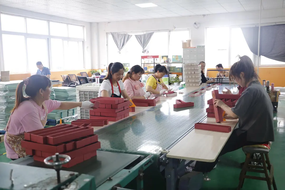 Packaging team reviewing components at a shared worktable