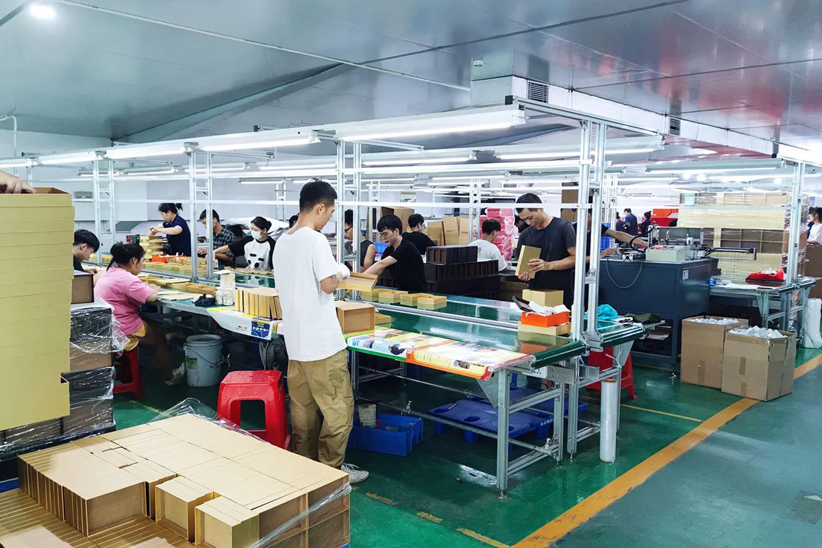 Finishing team completing custom boxes by hand