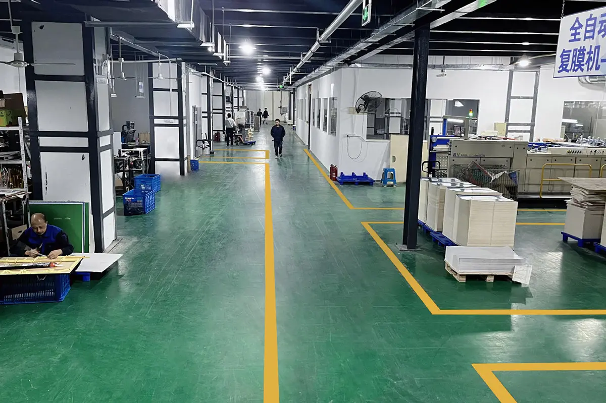 Marked production aisle connecting packaging work areas
