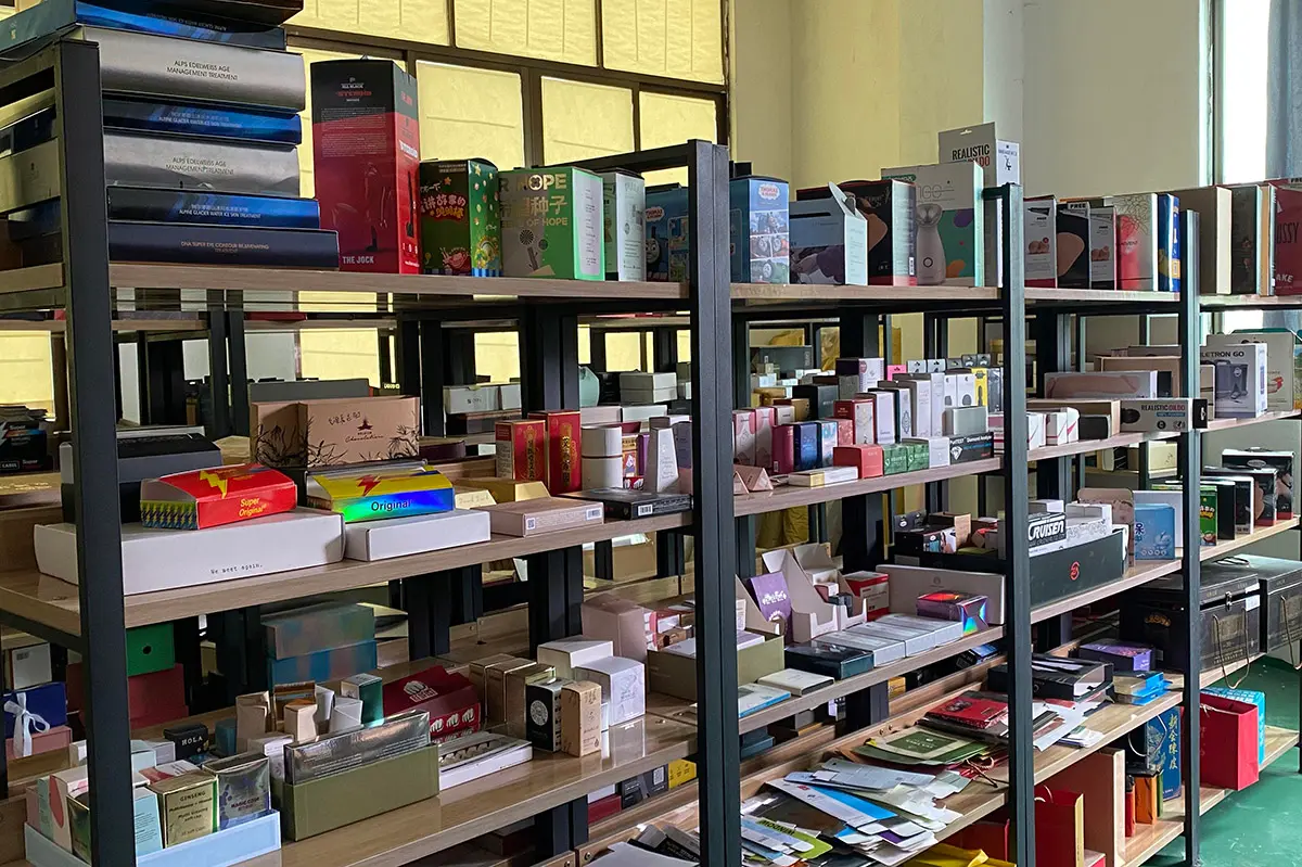Real corporate gift box samples organized on factory shelves
