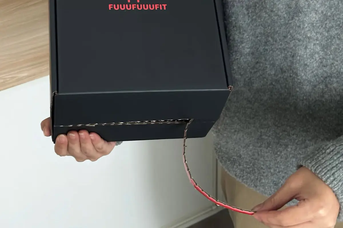 Black apparel magnetic gift box held open by hand